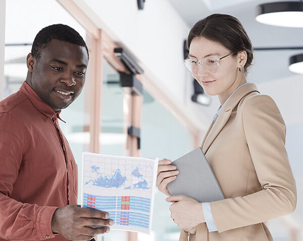 two-young-business-people-discussing-documents-in.jpg